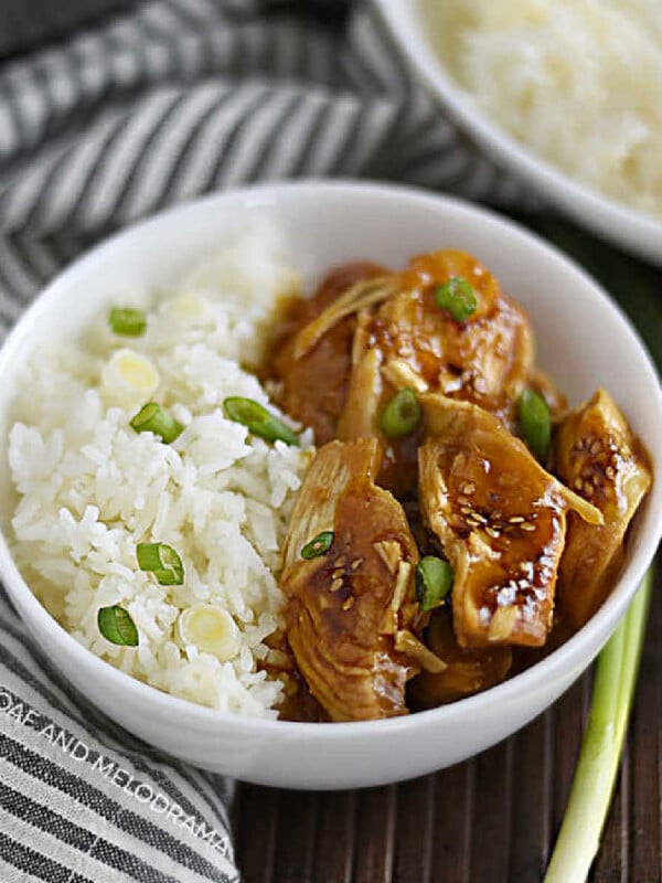 instant pot teriyaki chicken breasts with jasmine rice and green onions in a white bowl