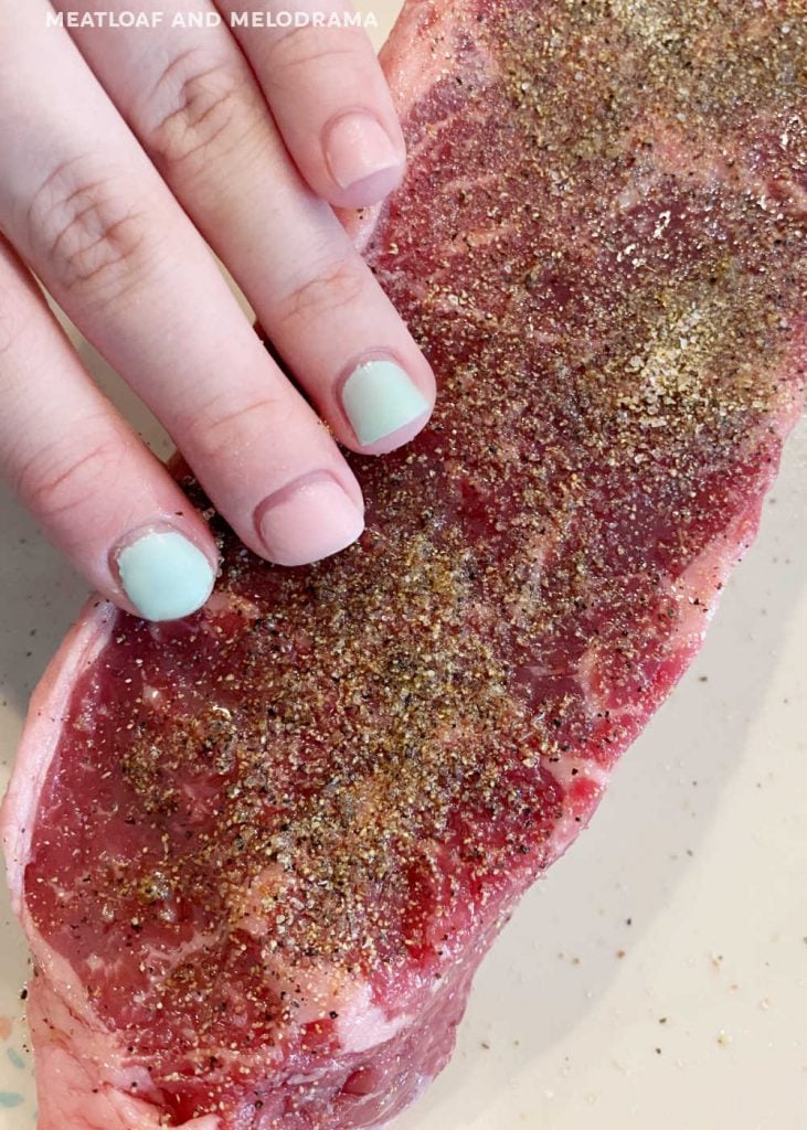 rub seasoning on new york strip steak