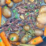 slow cooker pot roast with beef chuck potatoes carrots and celery in crock pot