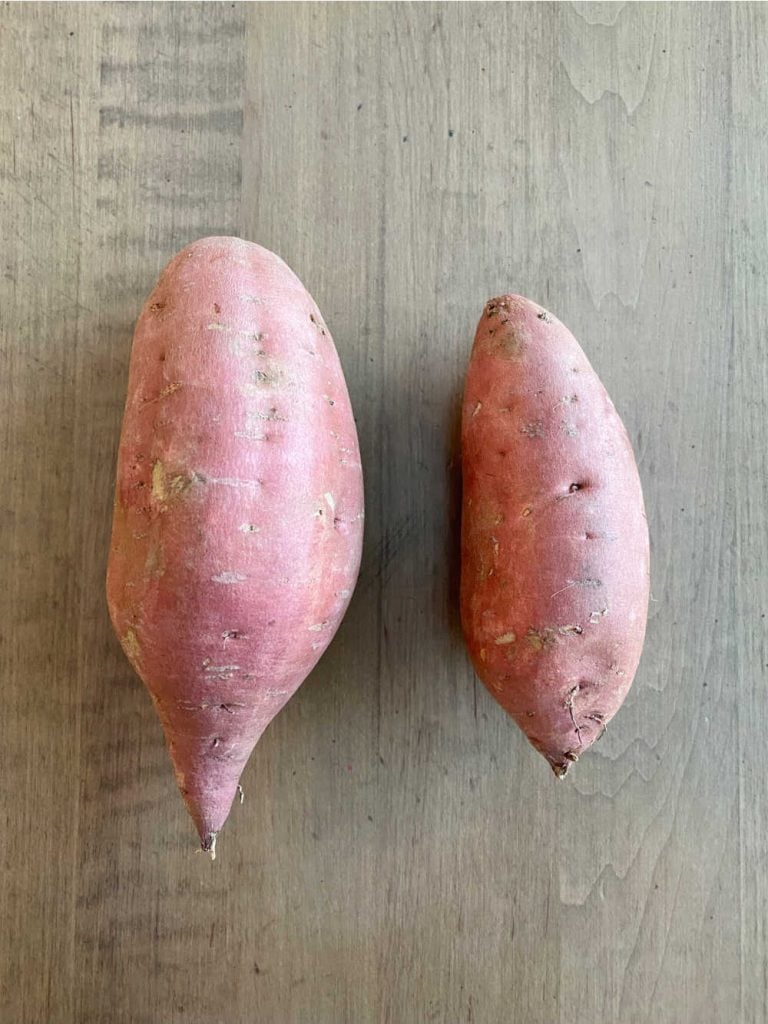 sweet potato size comparison  - 1 large sweet potato next to 1 small sweet potato uncooked