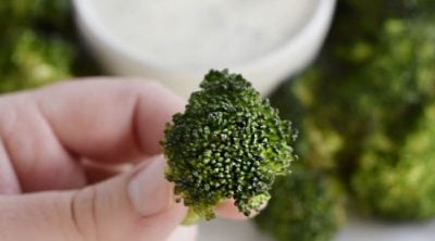 crispy air fryer broccoli in hand