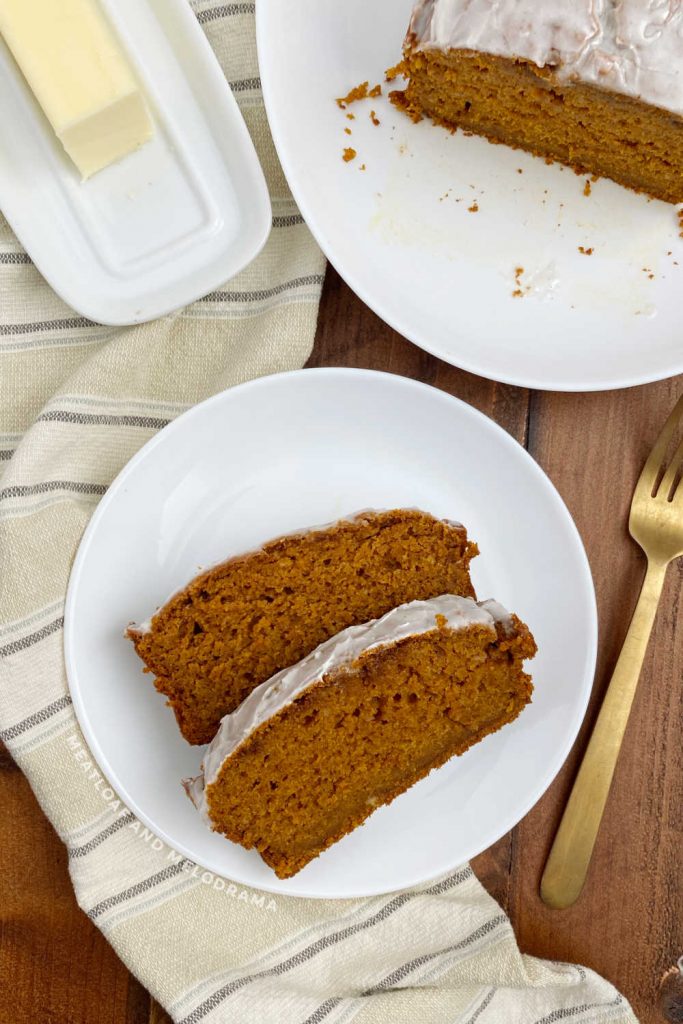 sliced pumpkin bread on a plate with loaf on the table