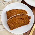 2 slices of pumpkin bread with cinnamon gaze on a white plate