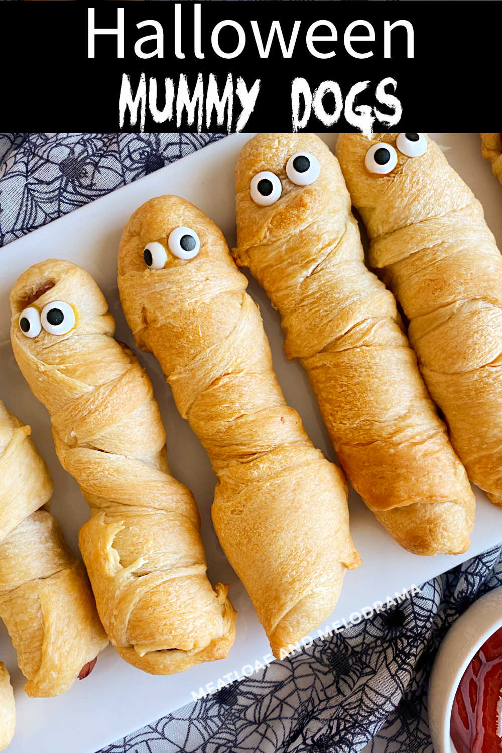 Crescent Mummy Dogs for Halloween made with hot dogs and crescent rolls are the perfect recipe to make for a quick Halloween dinner or Halloween part food. Kids of all ages love these easy hot dog mummies! via @meamel