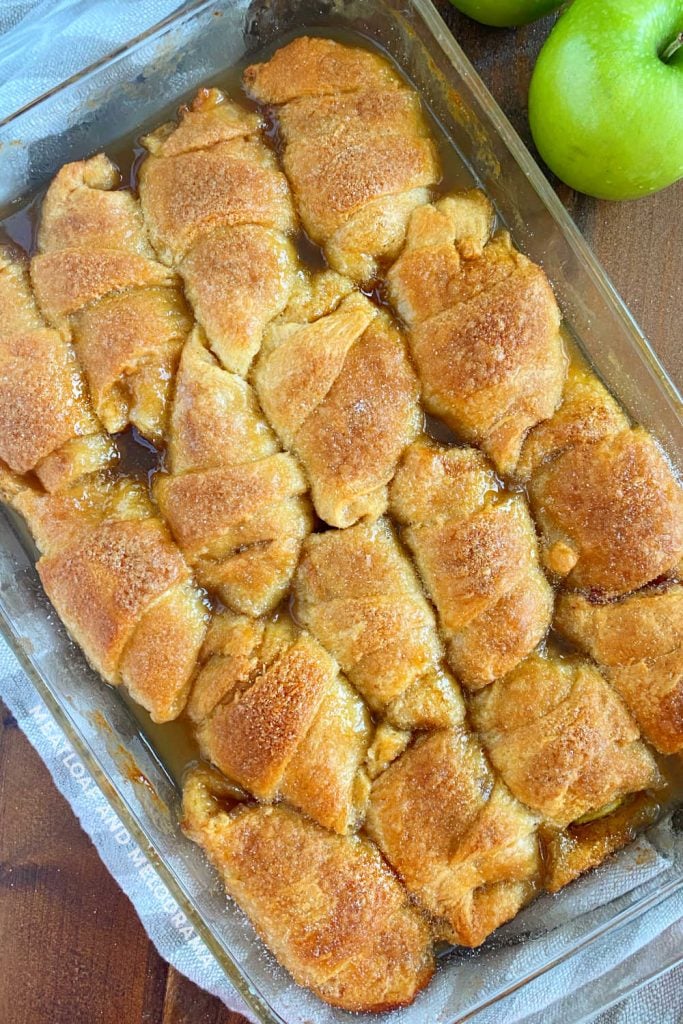 baked apple slices in crescent roll dough in caramel sauce