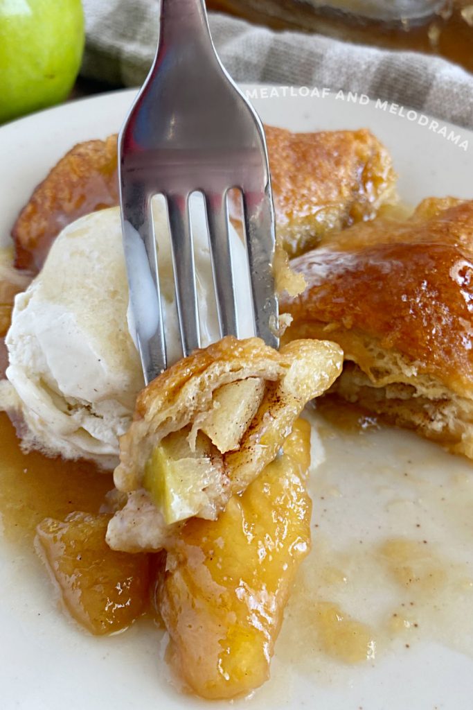 piece of apple dumpling on a fork with ice cream
