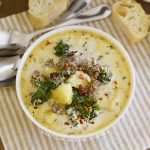 instant pot zuppa toscana with kale in white bowl with bacon and pepper flakes