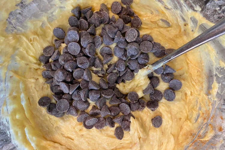 mix chocolate chips into pumpkin cookie batter