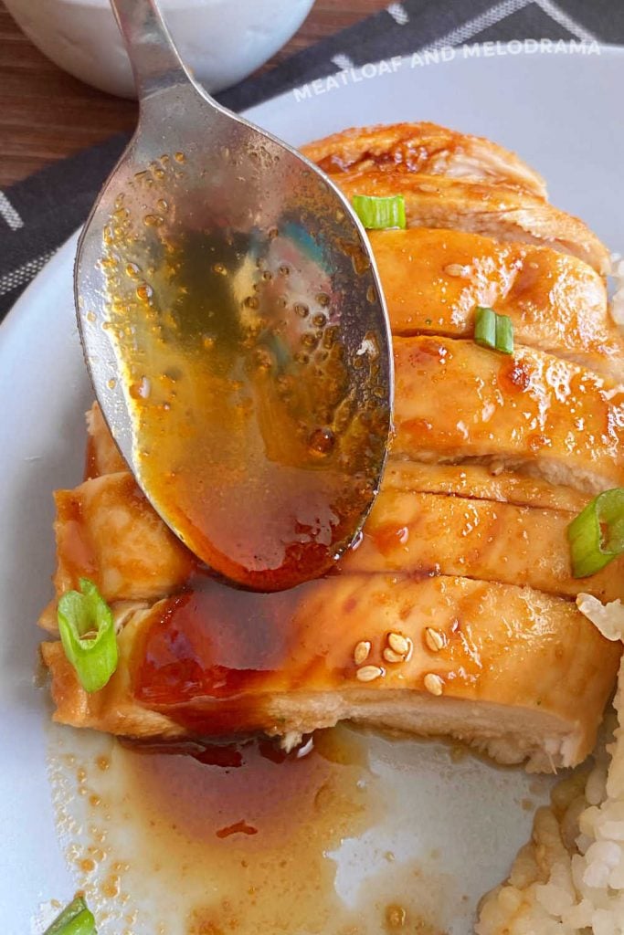 spoon reduced teriyaki sauce over sliced baked chicken breast