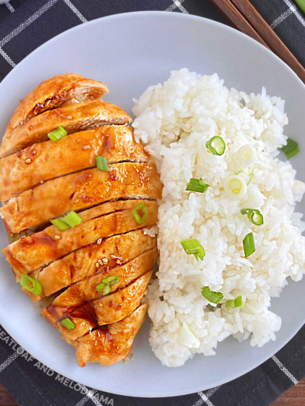 baked teriyaki chicken breast with green onions and white rice on grey plate