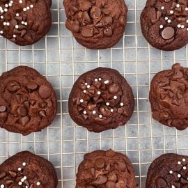 double chocolate chip cookies with cocoa powder and chocolate morsels on cookie rack