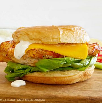 ninja foodi grilled buffalo chicken sandwich with American cheese, ranch dressing and lettuce on a bun