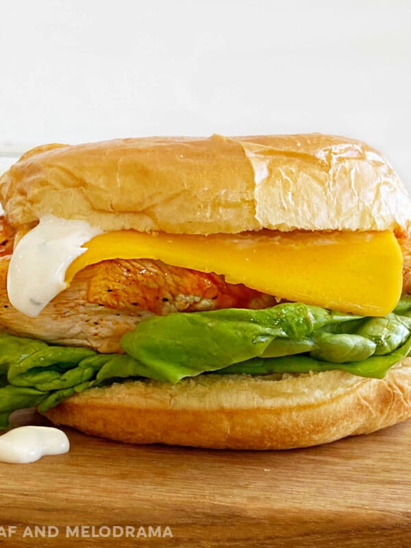 ninja foodi grilled buffalo chicken sandwich with American cheese, ranch dressing and lettuce on a bun