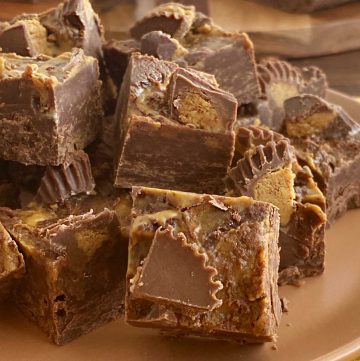 chocolate peanut butter fudge with Reese's peanut butter cups on a plate