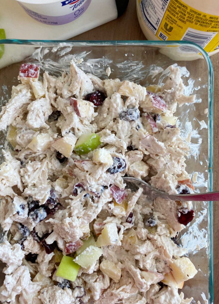 mix chicken salad ingredients together with spoon