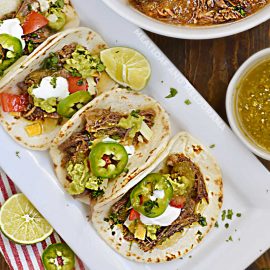 instant pot mexican shredded beef tacos with jalapeno peppers on platter