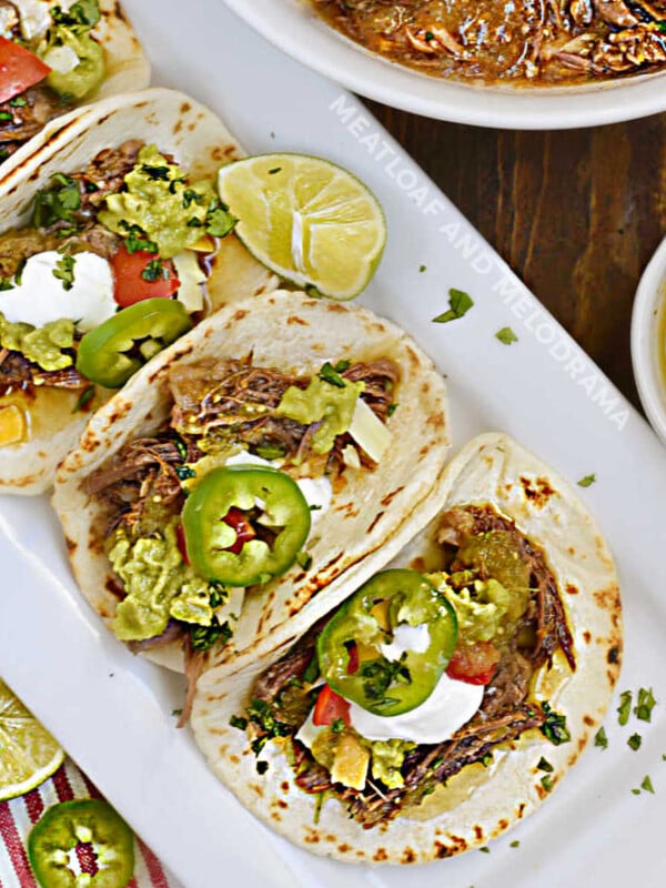 instant pot mexican shredded beef tacos with jalapeno peppers on platter