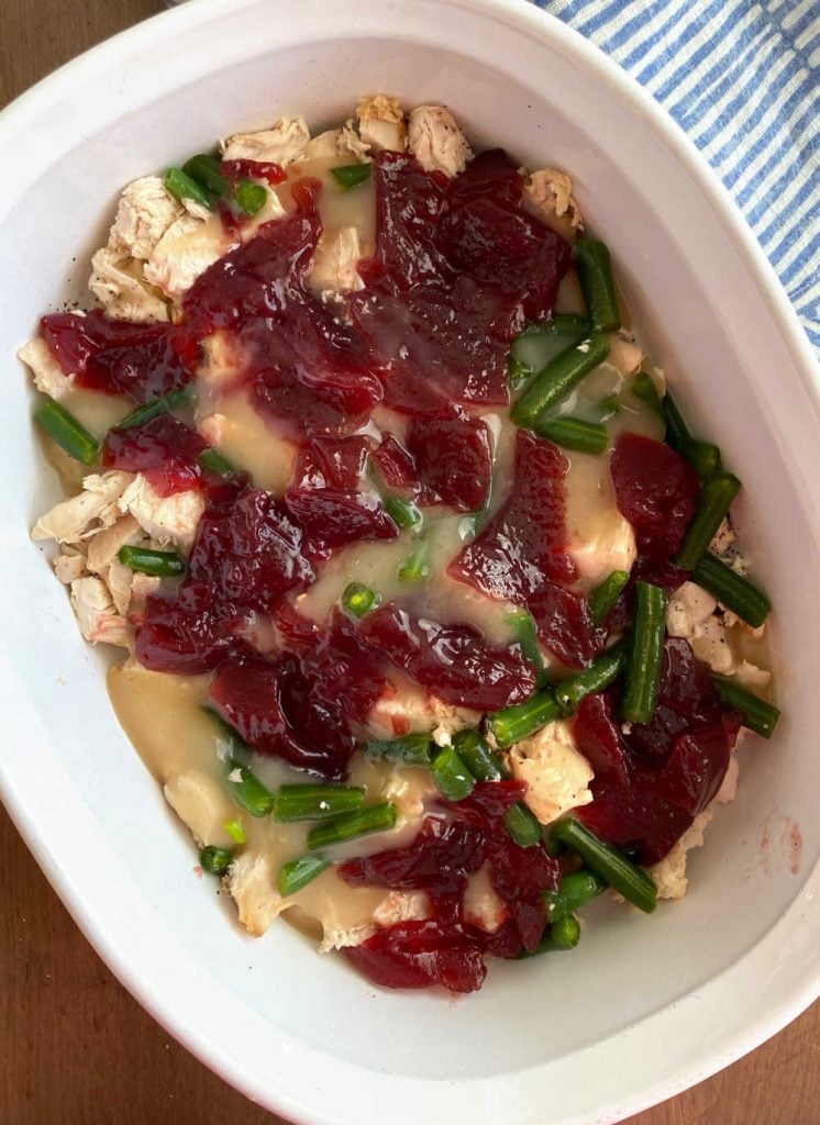 turkey, gravy, green beans and cranberry sauce in casserole dish