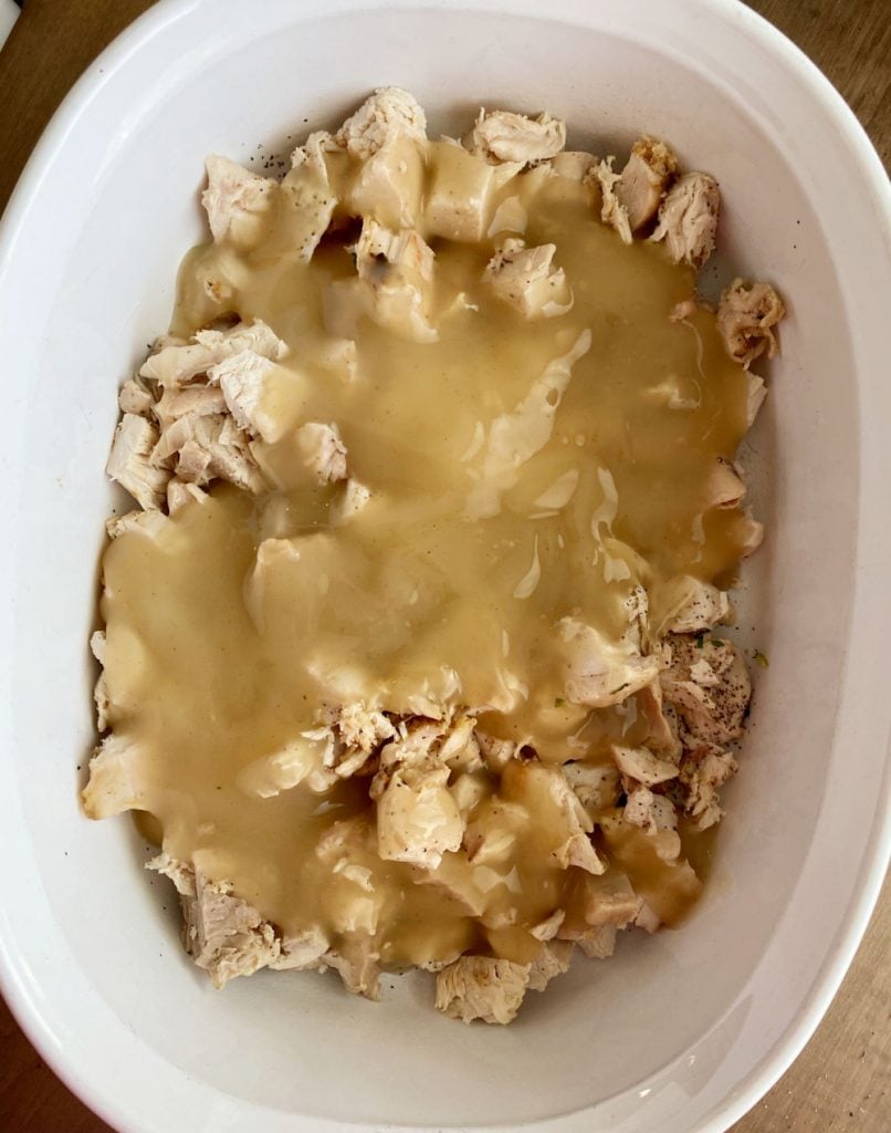 turkey gravy and cooked turkey in a casserole dish