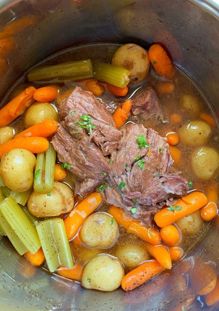 chuck roast with beef broth onions baby carrots and baby potatoes in pressure cooker