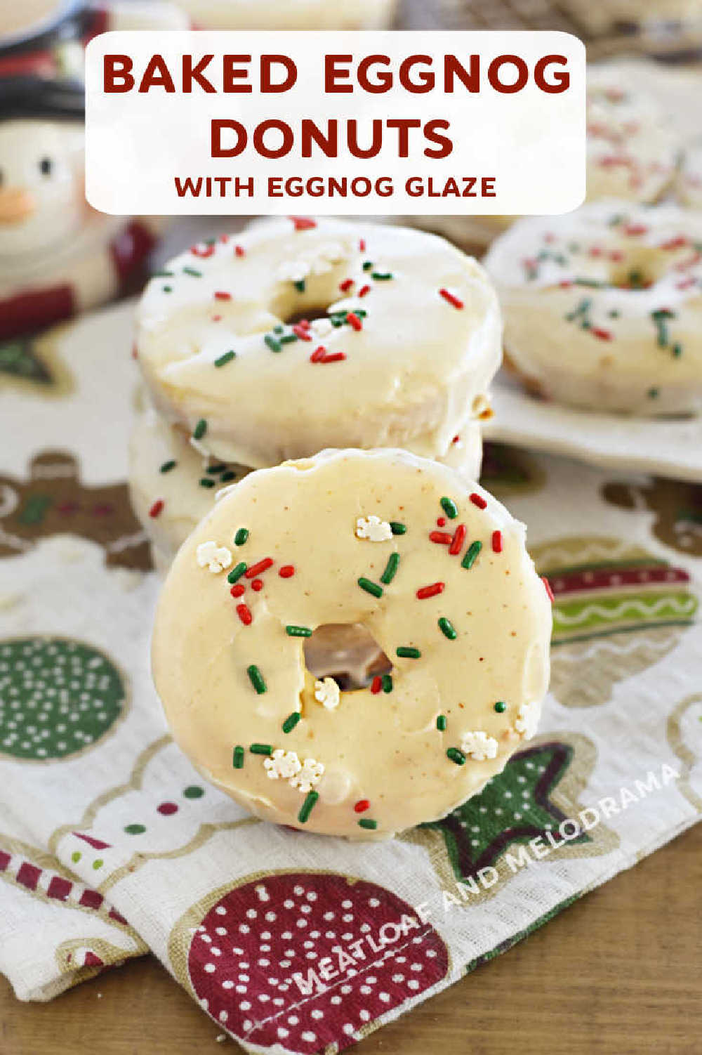 Baked Eggnog Donuts (Christmas Donuts) are made with cake mix and topped with an easy eggnog glaze. Perfect for Christmas morning breakfast and as a sweet treat throughout the holiday season! Your whole family will love this easy donut recipe! via @meamel