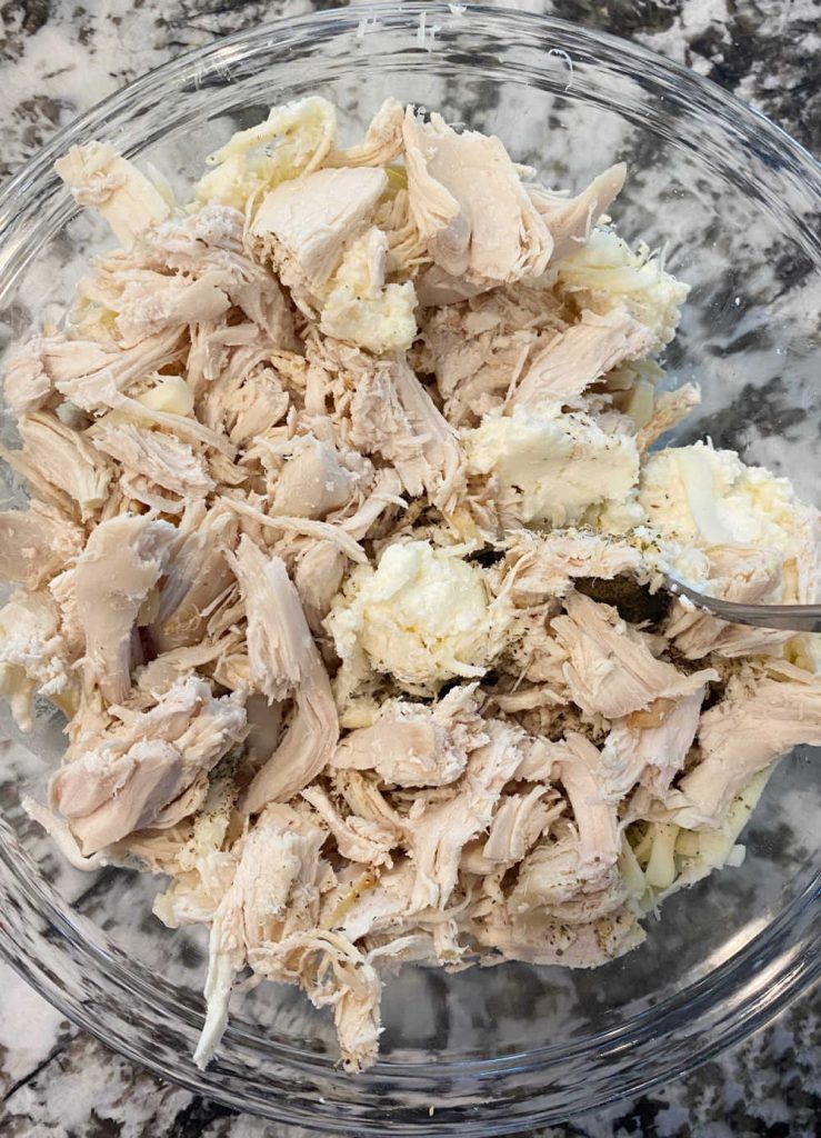 mix rotisserie chicken and ricotta cheese in mixing bowl