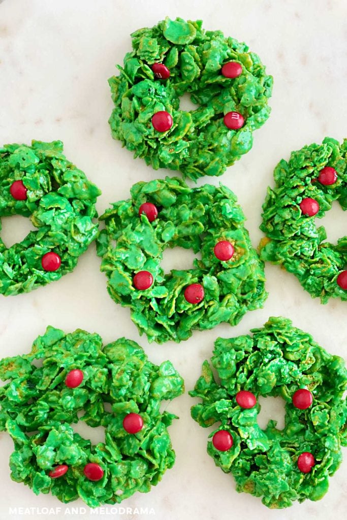 closeup of cornflake wreath cookies with red candies