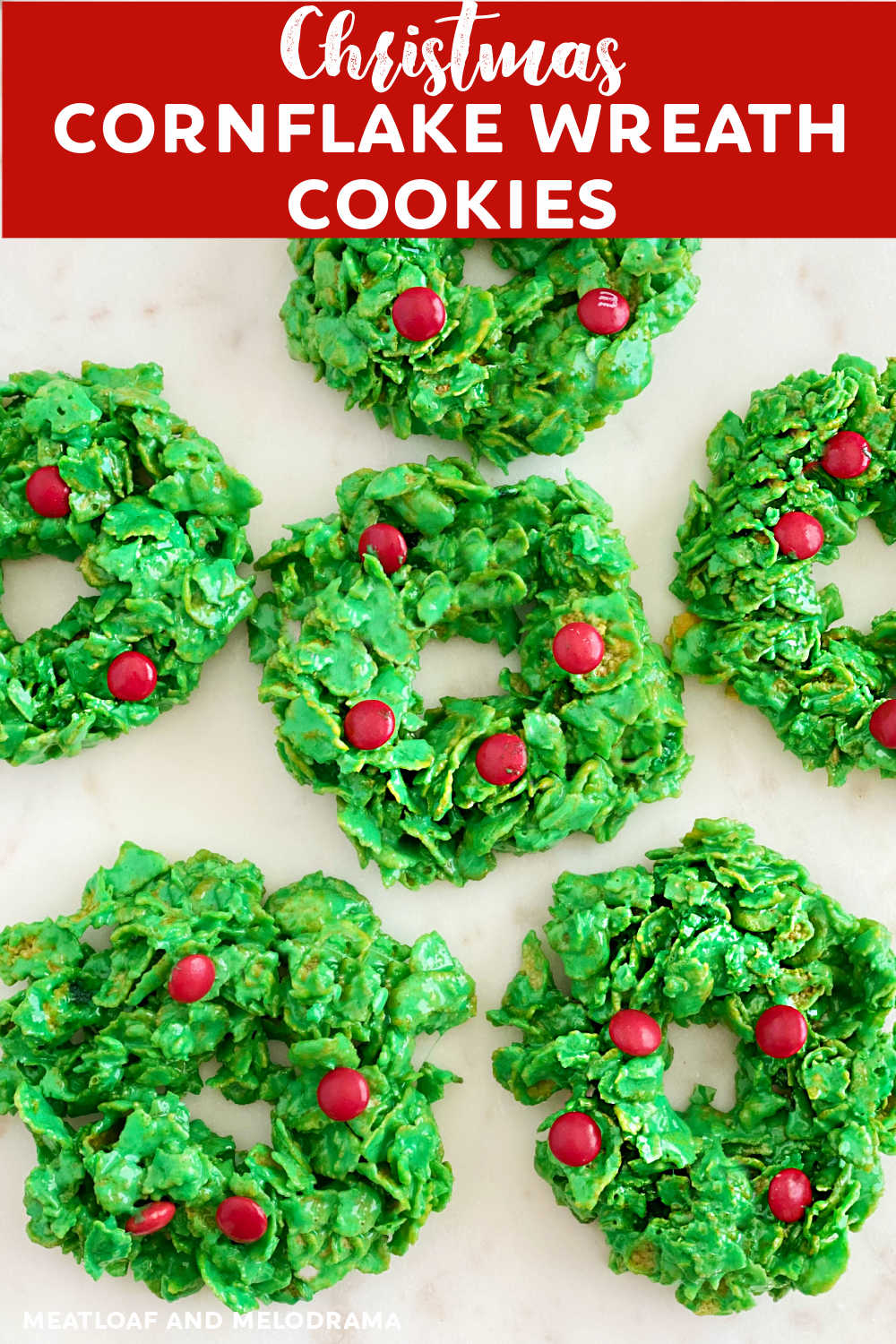 Christmas Cornflake Wreath Cookies are easy no bake treats made with corn flakes cereal, marshmallows, green food coloring and red candies. These cute Christmas wreaths are perfect for the holiday season and a fun addition to your holiday dessert table! via @meamel