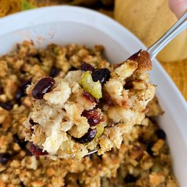 cranberry apple sausage stuffing on a serving spoon