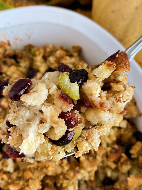 cranberry apple sausage stuffing on a serving spoon
