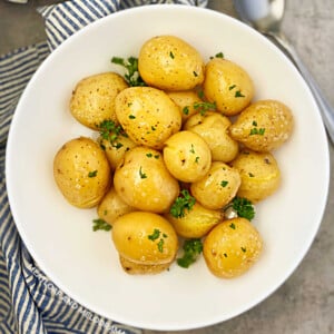 instant pot baby potatoes steamed until tender in a round white serving dish with parsley