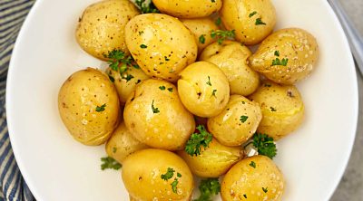 instant pot baby potatoes steamed until tender in a round white serving dish with parsley