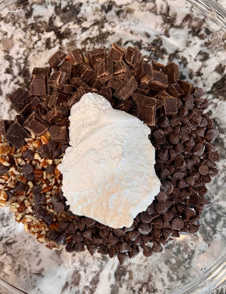 chocolate, nuts and marshmallow creme in mixing bowl