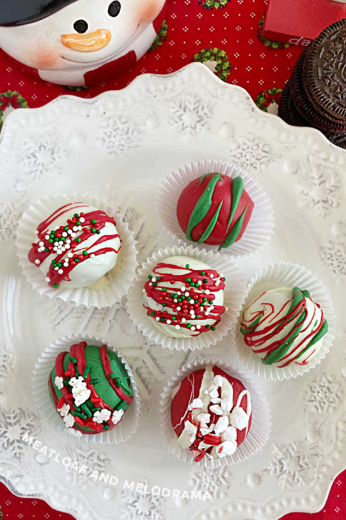 Oreo cake balls in Christmas colors on a white plate