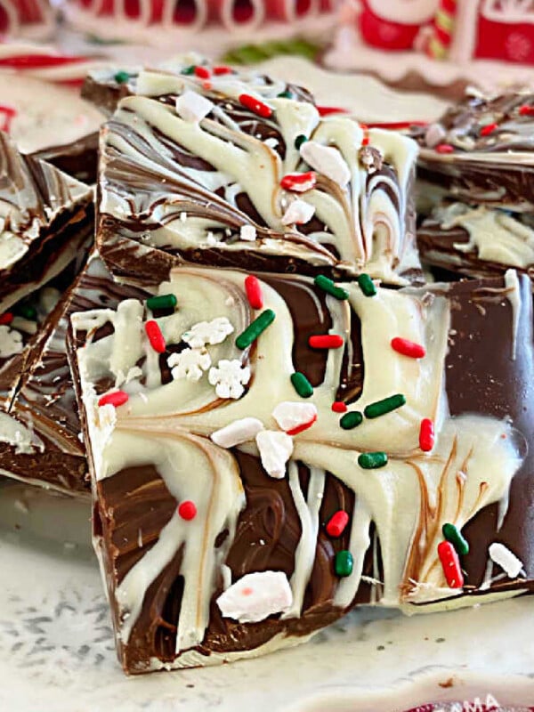 peppermint bark with swirled white chocolate and dark chocolate and crushed peppermint candies on a plate