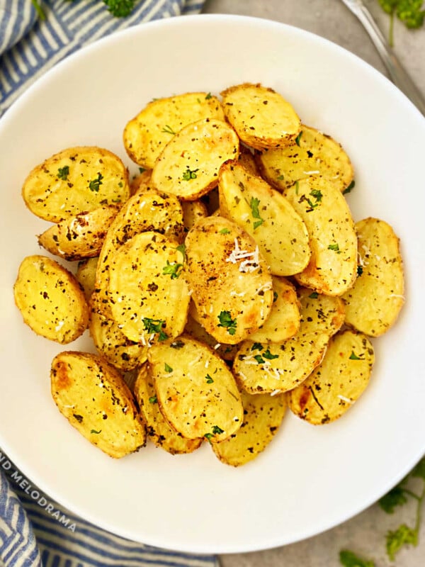 roasted baby dutch potatoes with fresh parsley and Parmesan in white bowl