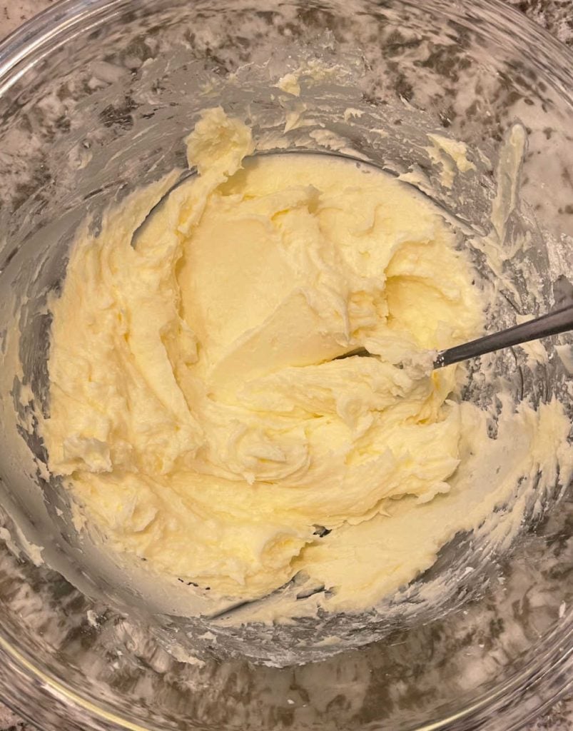 cream butter and powdered sugar in mixing bowl