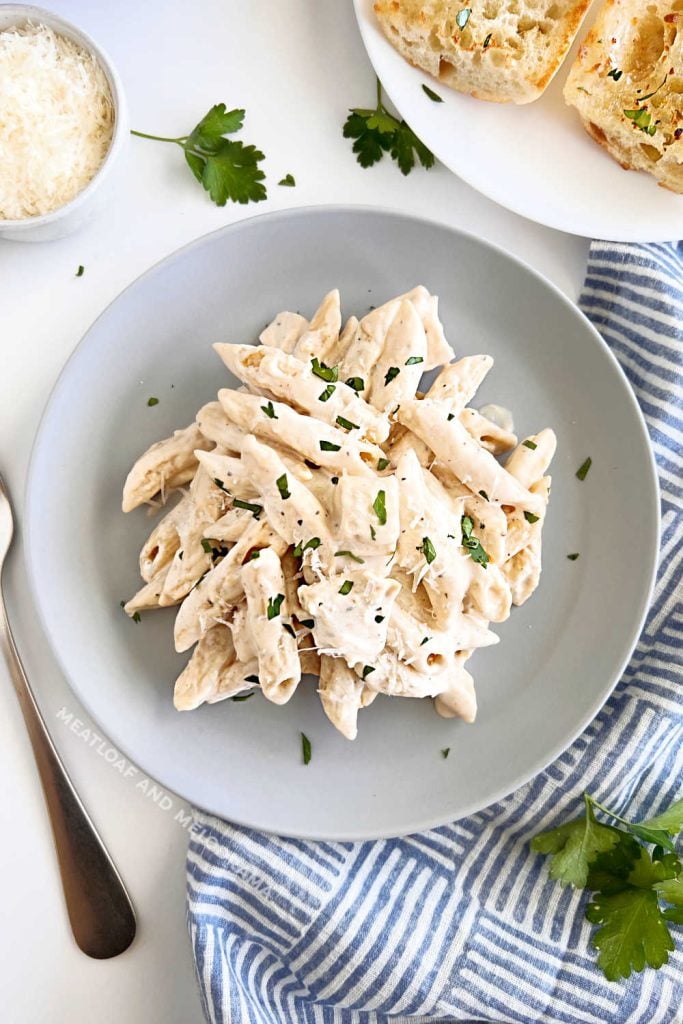 chicken alfredo penne pasta on the table