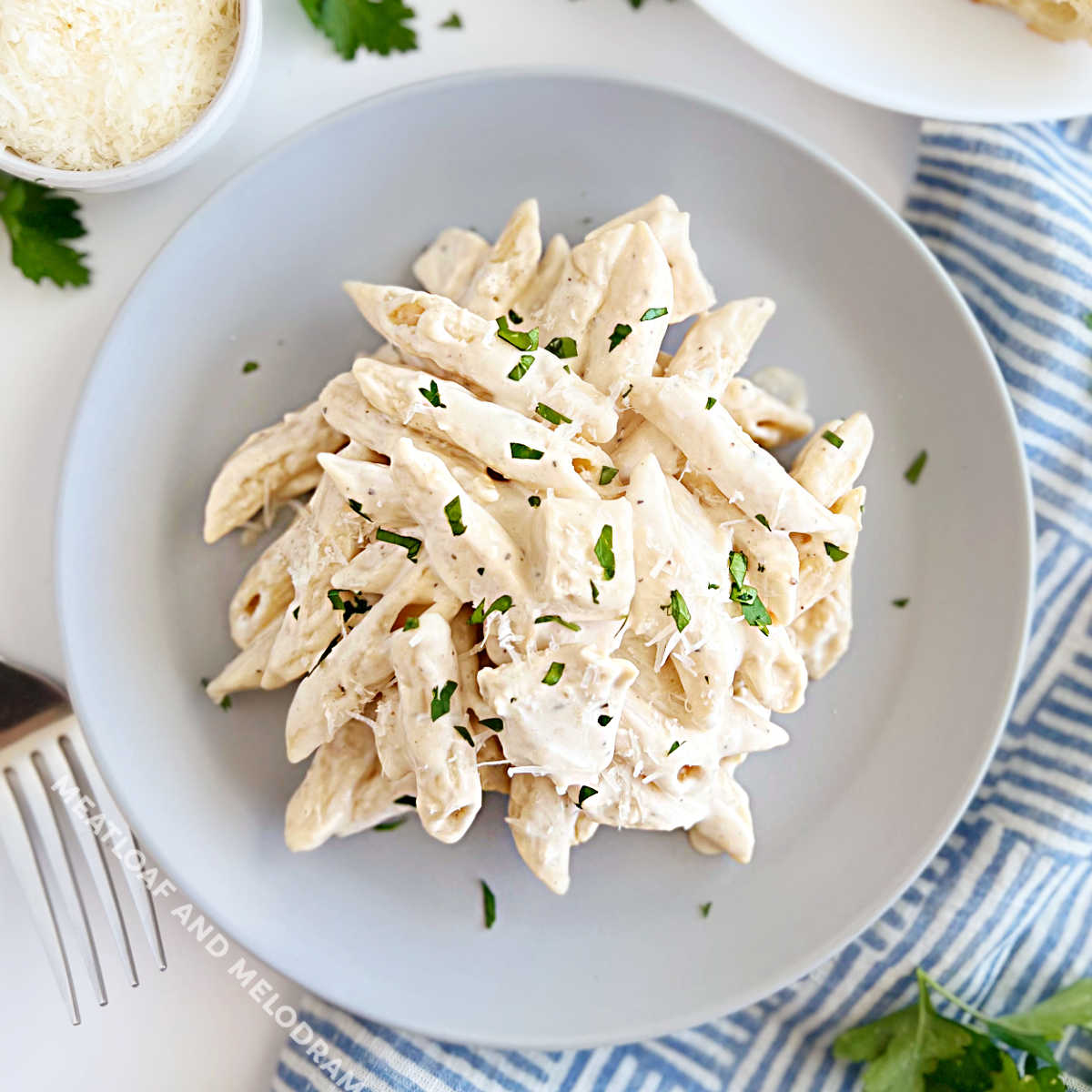 chicken alfredo penne pasta on blue plate