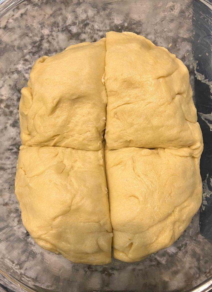 risen dough sliced in 4 pieces