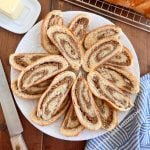 slices of grandma's nut roll with swirls walnut filling on a white platter