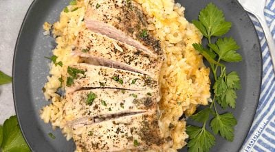 grandma's chicken and rice on a black plate with parsley