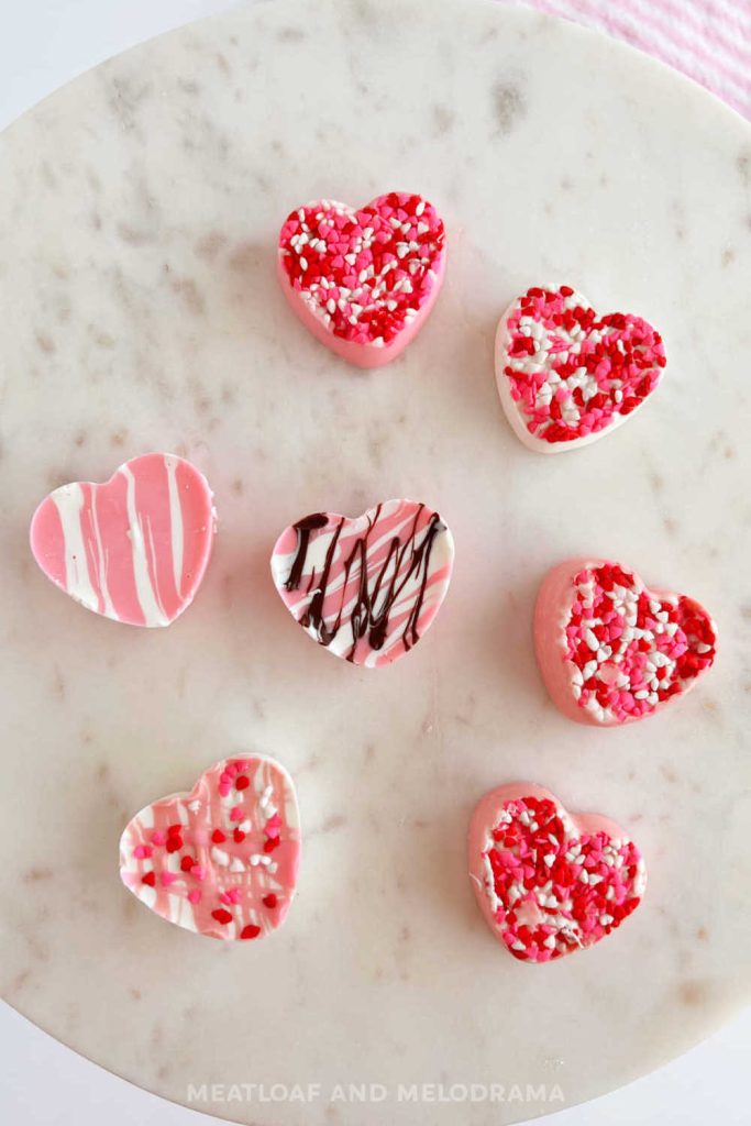 pink and white homemade chocolate hearts for valentine's day on marble cake stand