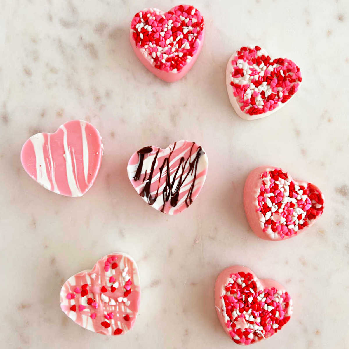 Chocolate cake balls stripped with pink candy melts for Valentines