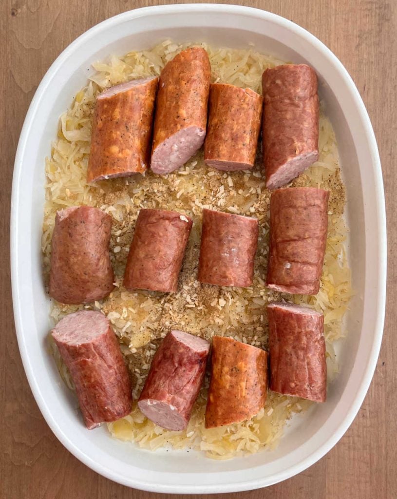 smoked sausage over sauerkraut in baking dish