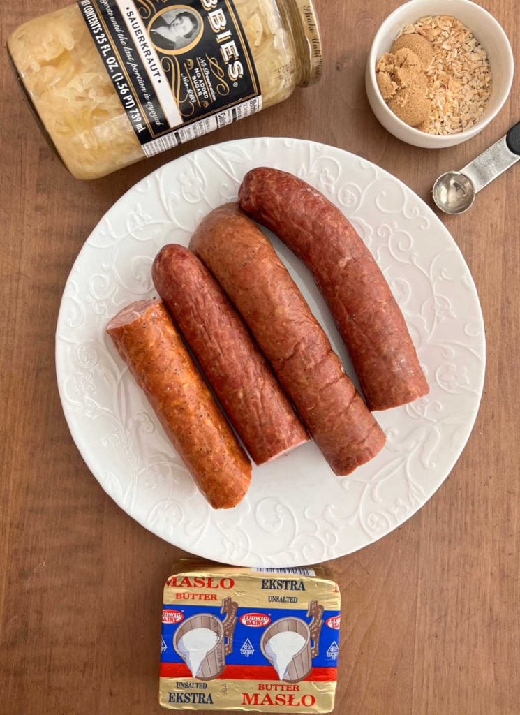 polish sausage, bubbies sauerkraut, spices and butter on the table