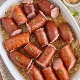 baked kielbasa and sauerkraut in casserole dish with parsely