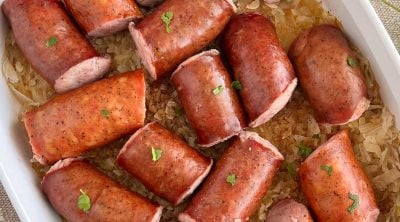 baked kielbasa and sauerkraut in casserole dish with parsely