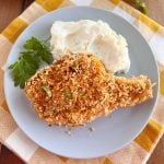 baked breaded pork chops with panko bread crumbs and mashed potatoes on plate