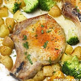 baked pork chops and potatoes on a sheet pan with broccoli